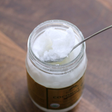 Jar of Coconut Oil from Bostan Set El Hosn, 250 gm, featuring a green and white checkered lid and a label with both Arabic and English text