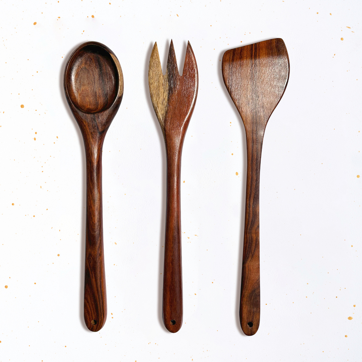 A set of wooden cooking utensils by GRIF, featuring a spatula, spoon, slotted spoon, and fork, made from high-quality wood.