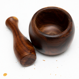 A wooden mortar by GRIF, perfect for grinding spices and herbs, featuring a natural wood finish and an ergonomic design this is a picture from a top side view.