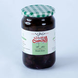 Jar of Black Olive Paste from Bostan Set El Hosn, 275gm, 700gm, featuring a green and white checkered lid and a label with both Arabic and English text.